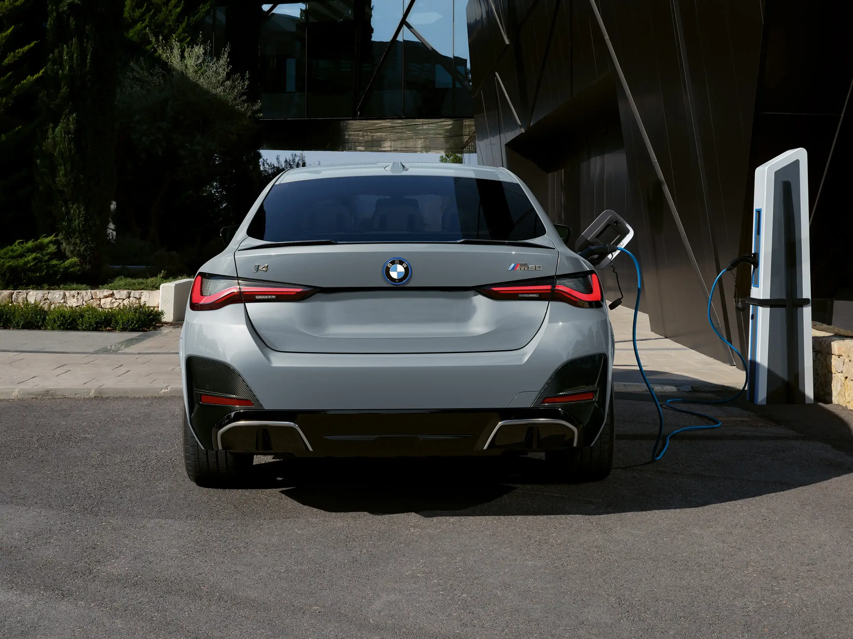 Rear photo of a BMW i4 m50 charging.